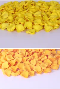 Close up of yellow and orange artificial rose petals for wedding decoration and party scatter.