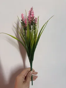 Close-up view of artificial pink lavender bouquet, realistic plastic floral decor.