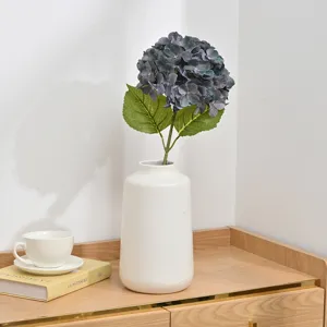 Artificial hydrangea flower stem in ceramic vase for home wedding floral decor arrangement.
