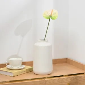 Artificial anthurium flower detail shot, realistic plant branch for home interior decor.