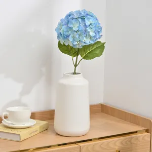 Artificial blue hydrangea flower in white ceramic vase for home wedding room decor
