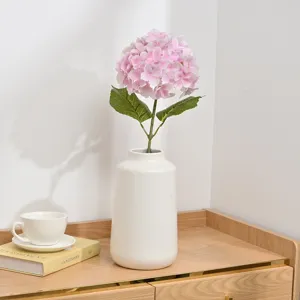 Artificial pink hydrangea flower in white ceramic vase for home wedding decoration table