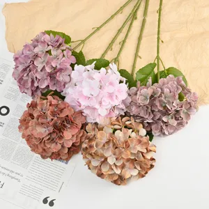 Artificial hydrangea flowers detail showing vibrant colored silk floral heads for wedding decor.