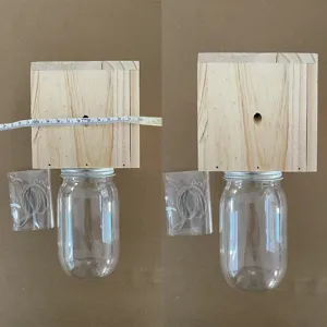 Wooden carpenter bee trap with transparent jar and hanging rope, ideal for outdoor pest control.