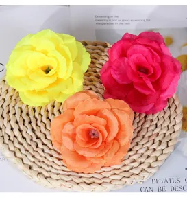 Artificial rose flower head detail, vibrant colors silk fabric material for wedding wall decor.