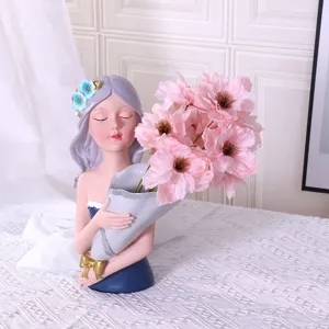 Resin girl bust vase with pink artificial peony bouquet for elegant home decoration and display.