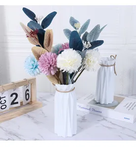Modern minimalist white plastic vase with artificial flowers home decor table centerpiece.