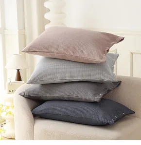 Cotton gauze pillowcase detail showing plaid design with snap button closure in various colors.