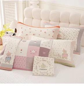 Detail view of cute cartoon pillow towels featuring sweet pumpkin and bear patterns for cozy home.
