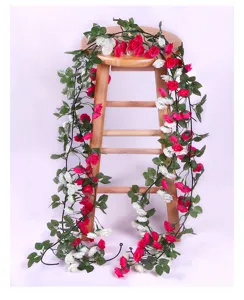 Artificial rose vine detail, silk red and white flowers with green leaves for home decor.