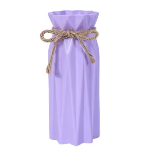 Modern purple plastic flower vase with rustic hemp rope bow, minimalist home decoration.