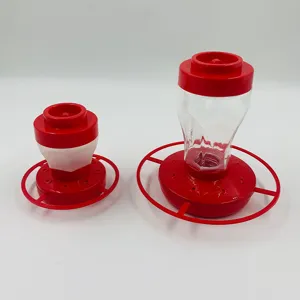 Abnehmbarer Kunststoff-Kolibri-Futterautomat mit rotem Sockel und Fütterungsöffnungen für Garten.