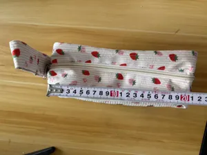Corduroy pencil pouch detail showing size, portable double-layer strawberry stationery bag.