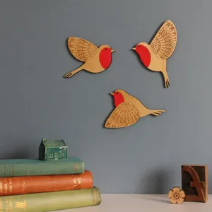 Wooden flying bird wall decor detail, set of three decorative wall hangings, natural wood craft.