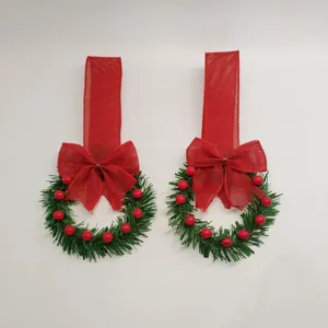 Mini Christmas wreath with berries and bow, hanging ribbon pendant for holiday cabinet decoration.