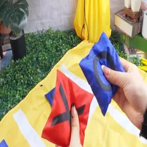 Outdoor bean bag tossing game detail showing colorful toss bags and game mat for family fun.