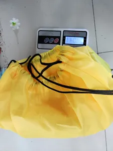 Yellow drawstring storage bag for outdoor throwing game props, durable fabric material.