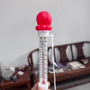 Drijvende zwembadthermometer met grappige rode tekentop, Fahrenheit- en Celsiustemperatuurschalen.