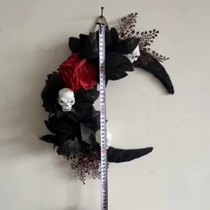 Halloween black crescent moon wreath with skulls and red roses for spooky holiday home decor