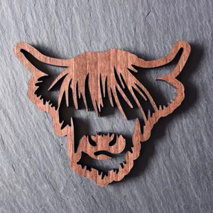 Close-up detail of highland cow wooden coaster, natural wood grain, exquisite hallow design.