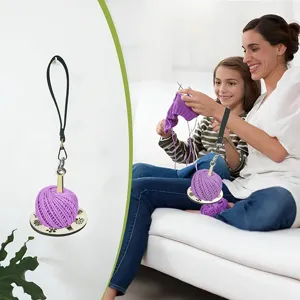 Portable wrist yarn holder with wooden base for knitting, convenient craft tool accessory.