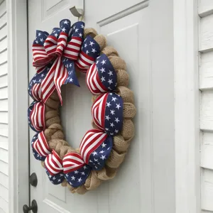 Close-up of patriotic burlap wreath with American flag ribbons for door decoration.