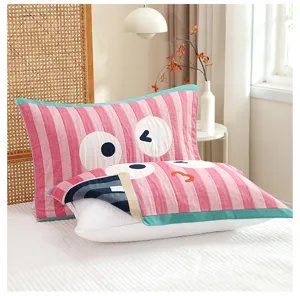 Soft and breathable gauze pillow towel with cute cartoon eyes print for home use.