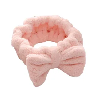 Pink bow coral fleece headband for facial skincare and makeup, soft spa hair band.