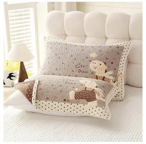 Detail view of soft gauze pillow towel featuring cute cartoon dinosaur pattern for home decor.