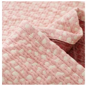 Close-up detail view of the soft gauze pillow towel fabric texture in pink and white color.
