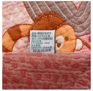 Detailed view of soft cotton gauze pillowcase fabric texture and product label close-up.