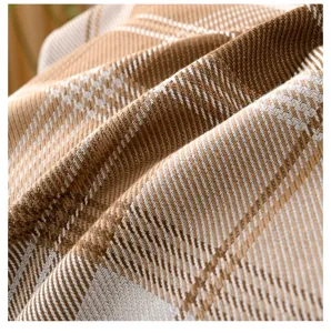 Close-up detail of the soft breathable cotton twill fabric with classic brown plaid.