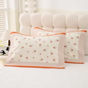 Cozy floral cotton pillow cover with orange grid border, soft and breathable home bedding.