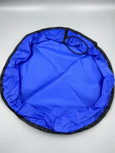 Detailed view of the large blue waterproof toy storage bag with black drawstring and edges.