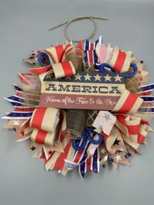 Detailed view of American Independence Day decorative wreath with red white and blue ribbons.