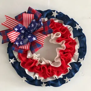 Detailed close-up of the patriotic American flag wreath with red, white and blue ruffled fabric.