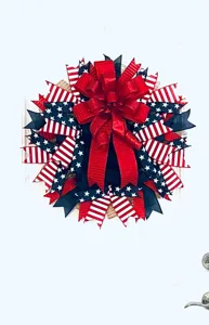Detailed close-up of 4th of July patriotic wreath with red white blue ribbons and bow.