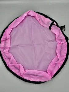 Detail close-up of the large pink and black round waterproof toy storage drawstring bag.