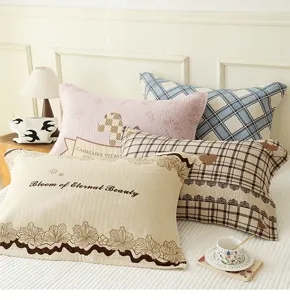Detail shot of soft cotton gauze pillow towels with floral and plaid patterns for bedroom use.
