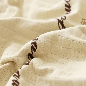 Triple layer gauze cotton pillowcase with soft texture and chic woven script design.