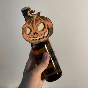 Detailed view of Halloween wooden pumpkin bottle hanger, festive party decoration prop.