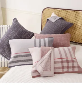 Close-up detail of soft breathable cotton gauze pillow covers in assorted plaid and striped patterns.