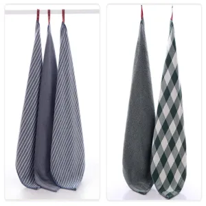 Cotton hanging hand towels in striped, solid and plaid patterns for kitchen and bathroom use.