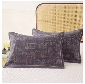 Textured cotton gauze pillowcases detail, showing soft breathable fabric and elegant dark grey color.