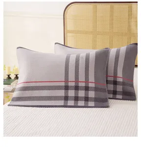 Soft cotton gauze pillow cover featuring classic plaid pattern, comfortable home bedroom use.