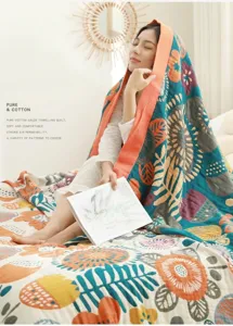 Detail of 5-layer pure cotton gauze towel quilt with soft breathable fabric and floral print.