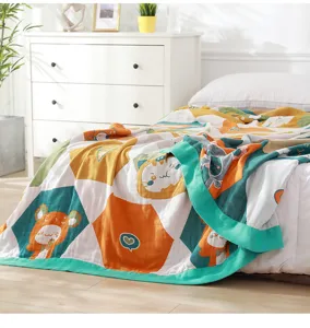 Details of the five-layer gauze blanket featuring cute cartoon patterns and soft breathable fabric.