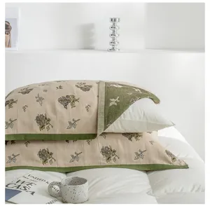 Detail shot of breathable cotton gauze pillowcase with retro floral pattern and green edge.