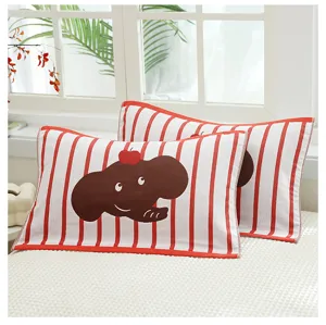 Detail shot of the cotton gauze pillow towel with cute cartoon elephant design and stripes.