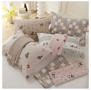 Detailed view of cute cartoon cotton pillow towels, soft gauze bed linen for home use.